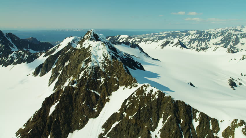 Aerial view of barren landscape and snow capped mountains Alaska