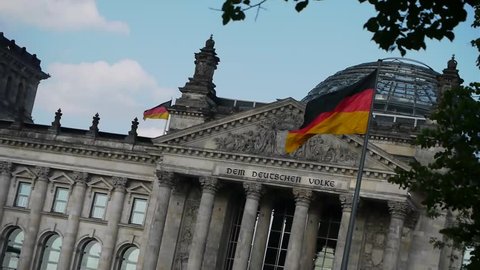 Reichstag - German Parliament in Berlin with waving flags