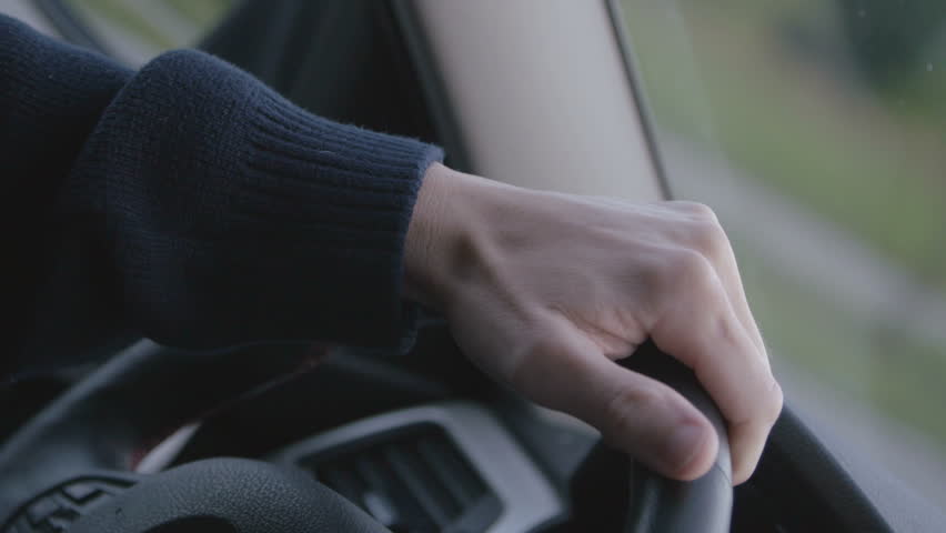 Hand on steering wheel. Man driving a car | Shutterstock HD Video #18719375