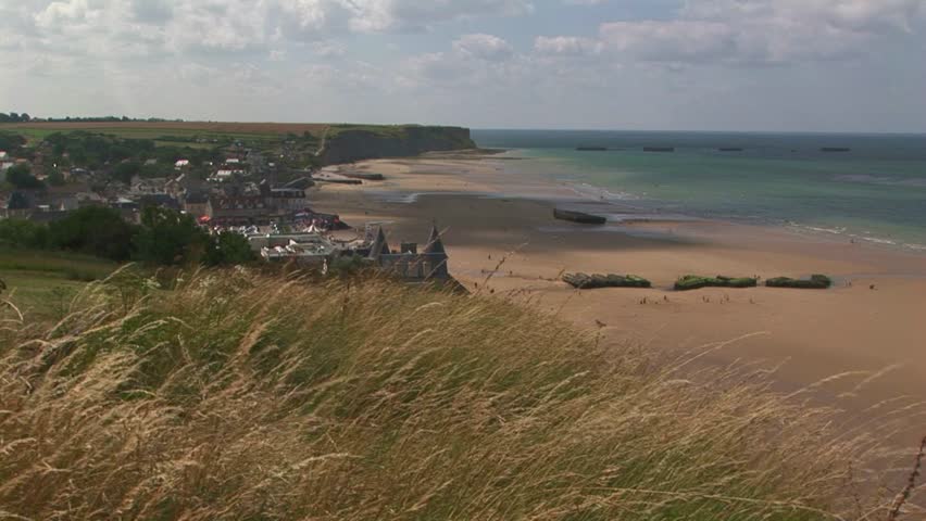 Moving clouds casting shadows over Gold Beach in Arromanches-les-Bains where the Normandy landings took place on D-Day June 6th 1944 in Calvados Department Normandy, France