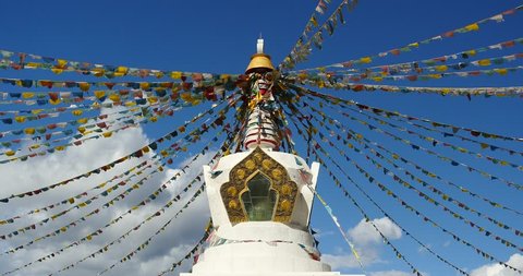 4k buddhist white stupa & flying prayer flags with blue sky background,shangrila yunnan,china. gh2_10472_4k