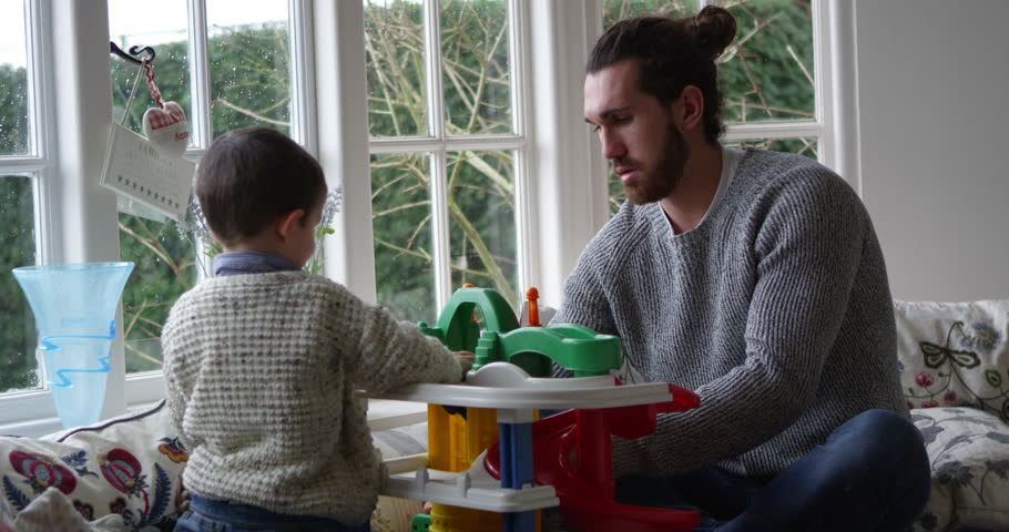 Father And Son Playing With Toy Garage In Window Seat, Shot on R3D