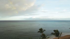 Early morning view of Molokai as seen from northern West Maui. Remnants of a rainbow are visible towards the upper left of the frame.