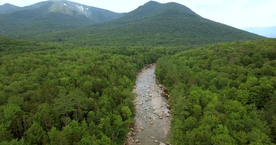 Birds eye view aerial footage over the rocky Pemigewasset river in the White Mountains of New Hampshire.