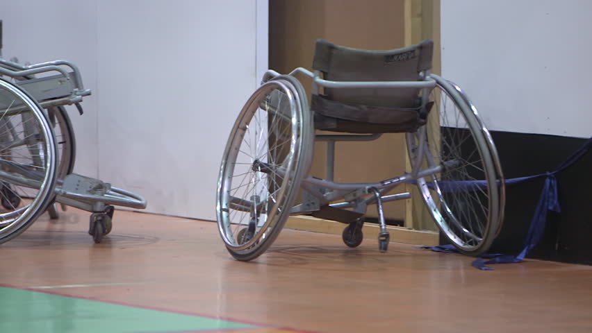 Wheelchairs. Pan-left CU on manual wheelchairs stacked in an indoor basket ball court. (Abu Dhabi - UAE-2013)