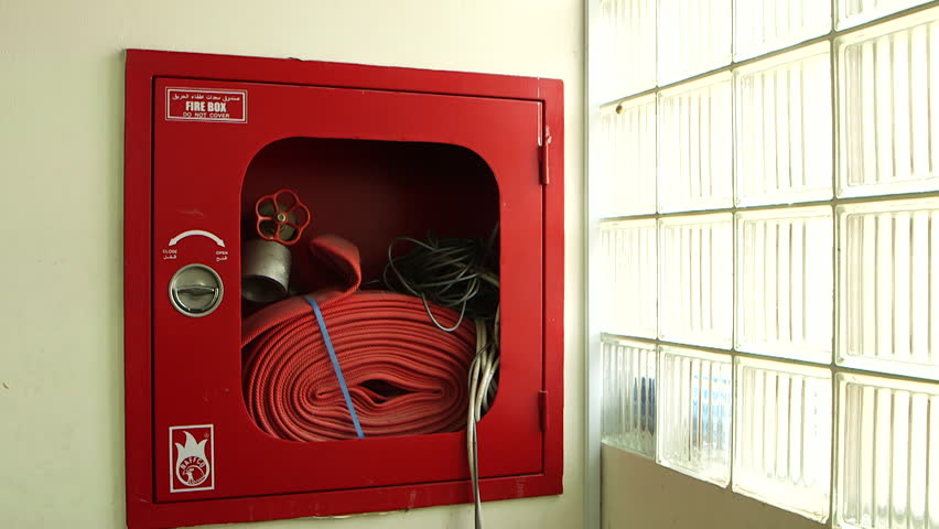 Fire Equipment. Pan-left across a messy fire hose cabinet with warning in English and Arabic. (Abu Dhabi, UAE-2013) Royalty-Free Stock Footage #18744869