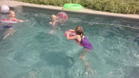 Children in the pool. Children throw Beach Ball. Slow motion