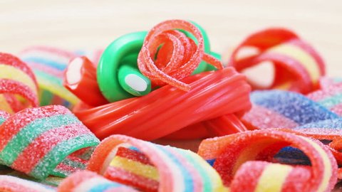 Colorful gummy candy (licorice) rotating sweets background, closeup view