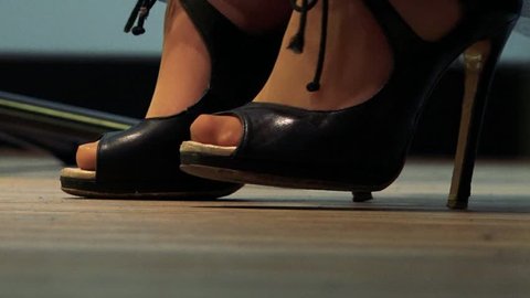 Woman with nice shoes tap her feet to rhythm - detail of shoes