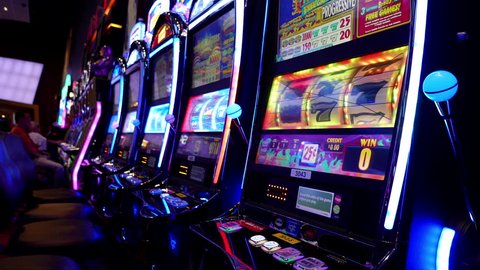 Coquitlam, BC, Canada - August 12, 2016 : Motion of people playing slot machine inside Hard Rock Casino with 4k resolution