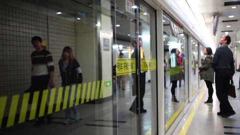 SHANGHAI, CHINA - NOV 6, 2015: People and glass doors of train in underground, Underground of Shanghai is 1st in world on extent subway lines (over 500 km)