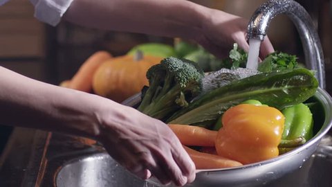 Scene of washing fresh vegetables. broccoli, pepper and carrots.  Under the tap. Shot on RED EPIC Cinema Camera in slow motion