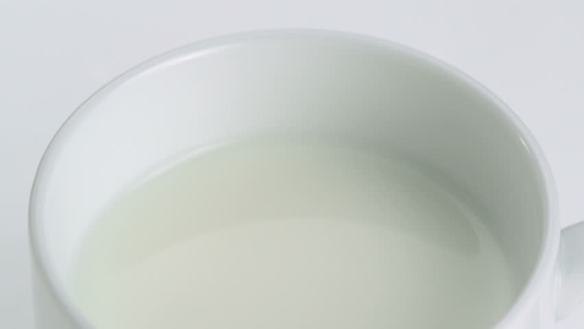 Close-up milk being poured into a white mug, Slow Motion Royalty-Free Stock Footage #1877836