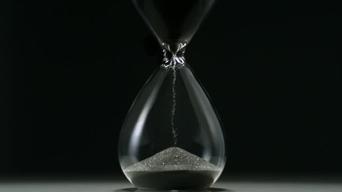 Sands move through hour glass