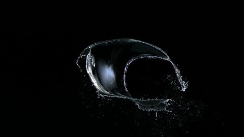 Water splash against black drop