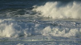Large coastal waves and water spray with strong winds  