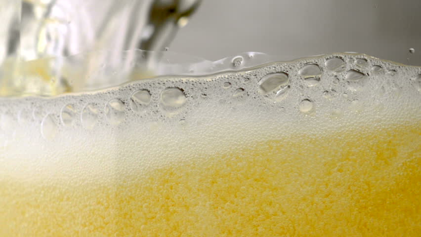 Extreme close-up beer bubbles in a glass while being poured Royalty-Free Stock Footage #1878328