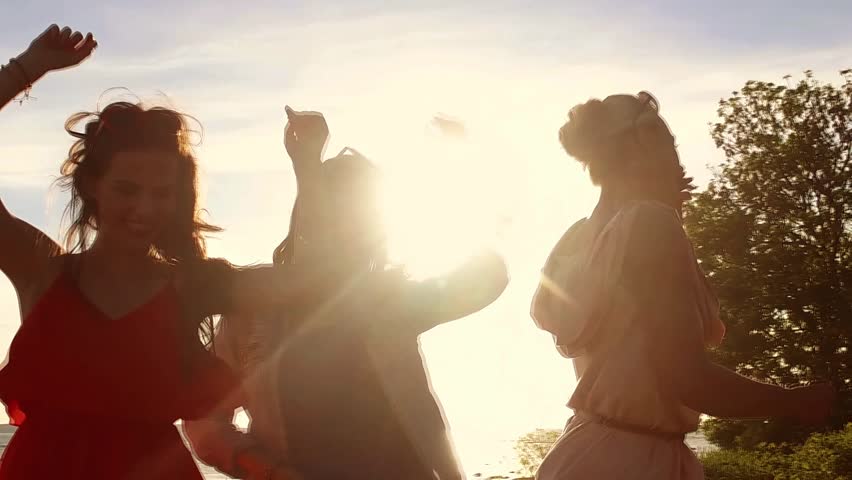 Summer vacation, holidays, leisure, travel and people concept - group of happy smiling young women or teenage girls dancing on evening beach in slow motion mode | Shutterstock HD Video #18783743
