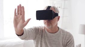 3d technology, augmented reality, gaming, entertainment and people concept - senior man with virtual headset or 3d glasses playing videogame at home