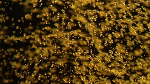 Extreme close-up beer bubbles in glass
