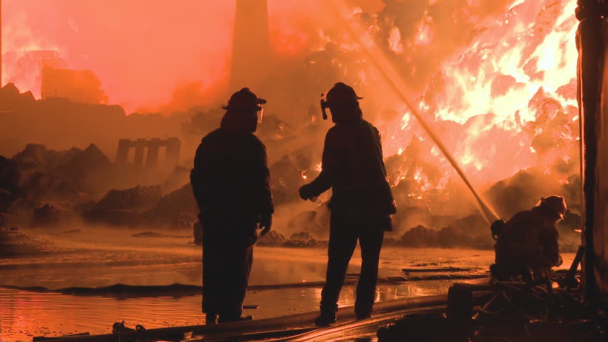 Firemen fighting huge Industrial fire