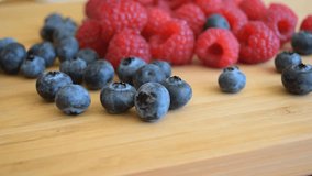 Fresh berries, blueberry and raspberry on the wooden table. 