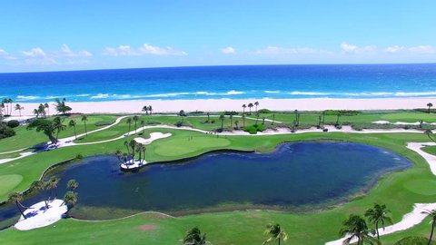 Aerial - Beautiful view of Golf Course next to ocean with beautiful ocean