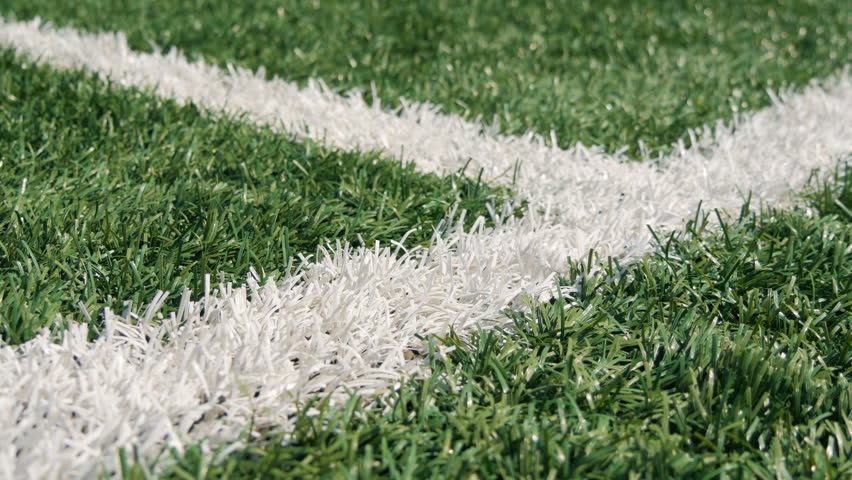 Close up of the out of bounds line on a turf football field. Green grass Royalty-Free Stock Footage #18801137