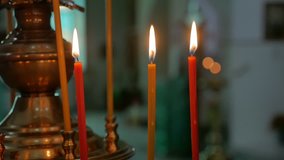 dark candles in the russian church orthodox of service sacrament indoors slow motion video