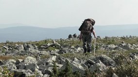 The man is hiking in the stone river mountains