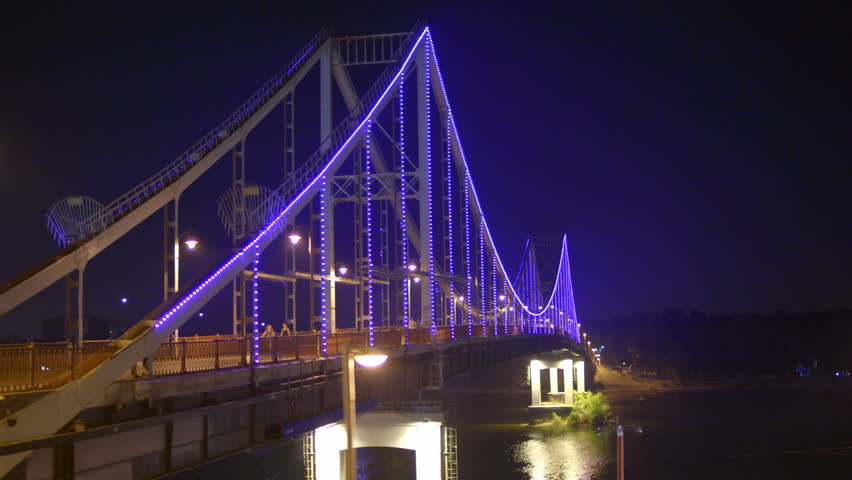 3 in 1 video! The picturesque backlight on the pedestrian bridge. Evening night time. Wide angle. Real time capture