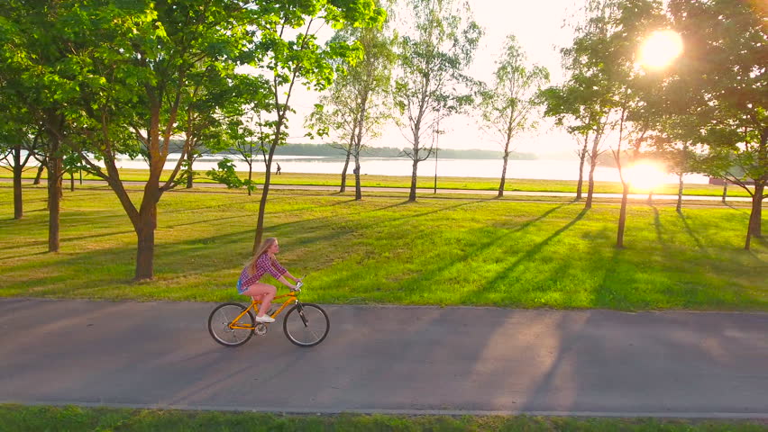 Young sexy woman riding a bike at dawn. 4K 30fps ProRes (HQ)