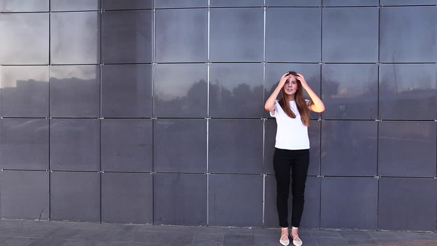 Woman girl lady portrait looking camera walking. Young beautiful student business female with long hair on the background building.