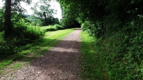 Smooth motion along an English countryside walkway and bridle-path.