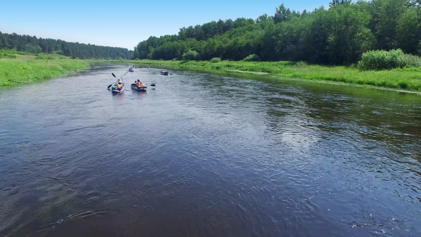 Tvertsa river with people travel on boats at summer day. Aerial view