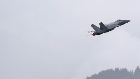 McDonnell Douglas F/A-18 of Swiss airforce do a looping in a bad weather day. McDonnell Douglas F/A-18 Hornet is a supersonic multirole combat aircraft. UltraHD 4K Video with original audio.