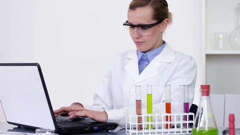 Female scientist working on laptop in laboratory