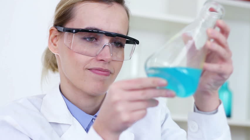 Female scientist mixing erlenmeyer flask with blue chemicals | Shutterstock HD Video #1883968