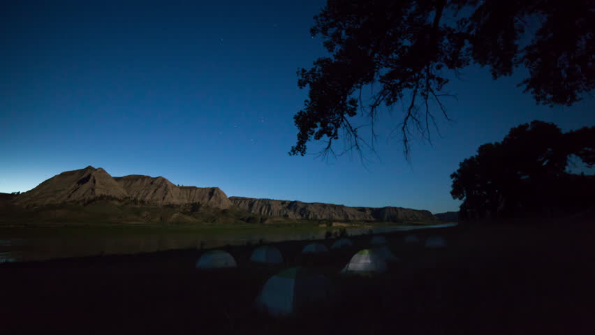 Time lapse - stars pass as moonlight shines on tent camp next to Missouri River - 5D_MO_Camp01Night