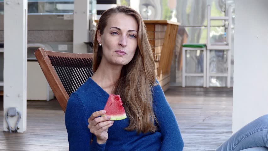 Beautiful Woman with watermelon in outdoor cafe. Summer.