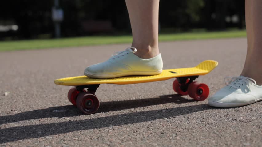 Skateboarding, leisure, extreme sport and people concept - teenage girl right foot on short modern skateboard | Shutterstock HD Video #18843728