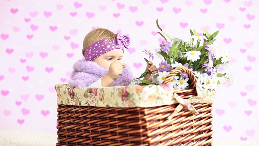 Little girl siting in a basket