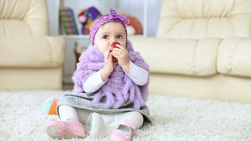Baby girl eating apple