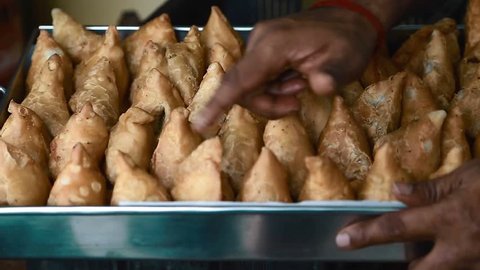 CHENNAI,INDIA - CIRCA August 2016 :Hand counting samosas in a tray