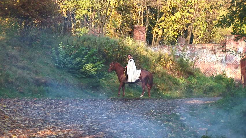 Knight on horseback in the autumn forest. Knights of the Teutonic Order in the robes of the Order with crosses.