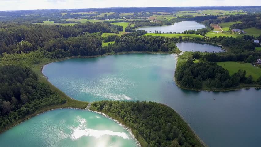 View of small islands on the lake in Masuria and Podlasie district, Poland. Blue water and whites clouds. Summer time. View from above.