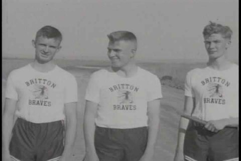 A member of the Britton Track Team throws a discus, boys wrestle, and the track team practices sprinting and running relays in Britton, South Dakota in the 1930s. (1930s)