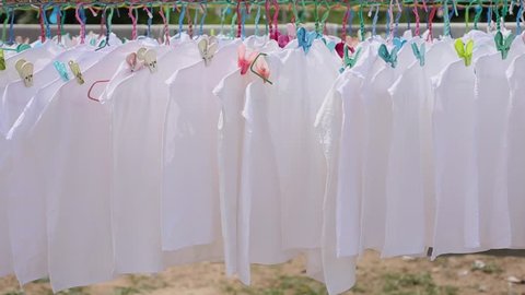 Closeup view of white laundry on summer day outdoor on the wind
