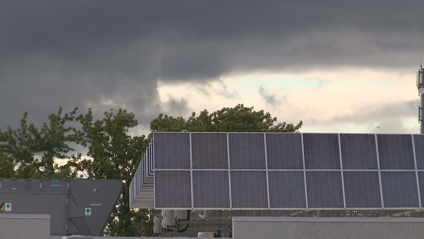 Waterloo, Ontario, Canada August 2016 Dark clouds block sun from solar energy panels on roof | Shutterstock HD Video #18885473