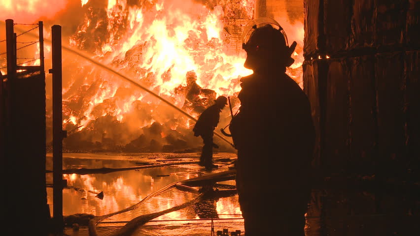 Firemen at a large industrial fire